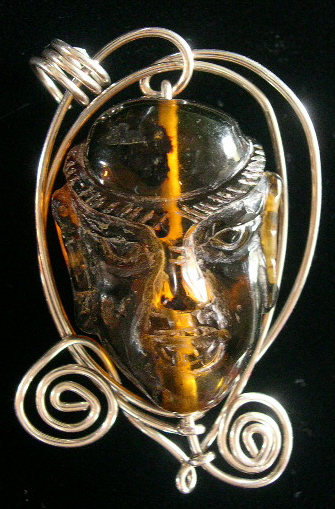 CARVED AMBER FACED PENDANT